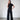 The black wide-legged pants, crafted from a ribbed fabric. Their slightly shorter length offers a contemporary twist, while the relaxed silhouette enhances comfort and style. 
