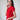 The side view highlights the elegant fit and ribbed texture of the red top. The modern silhouette and vibrant color enhance its contemporary appeal.