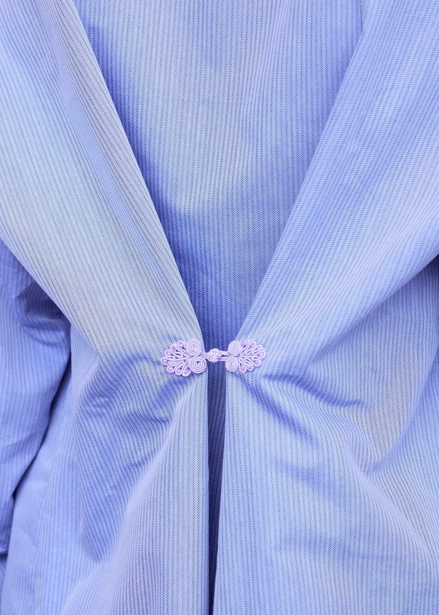 Close-up of an the purple pankou of the periwinkle blue oversize shirt